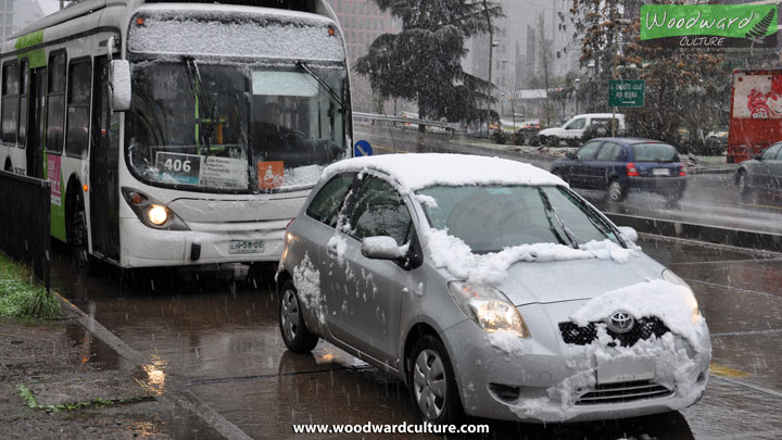 Bus and car covered in snow in Santiago, Chile - Woodward Culture