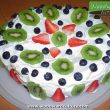 A homemade pavlova with kiwifruit, strawberries and blueberries on top - New Zealand Food - Woodward Culture