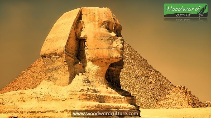 The head of the Sphinx of Giza in Egypt with pyramids in the background - Woodward Culture Travel Guide